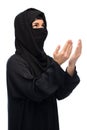 Praying muslim woman in hijab over white