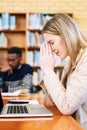 Praying that she passes these tests. a young woman looking stressed while sitting behind a laptop. Royalty Free Stock Photo