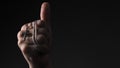 Praying with a rosary. hand of Catholic man with rosary on black background