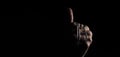 Praying with a rosary. hand of Catholic man with rosary on black background