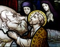 Praying for the soul of a dead lady (stained glass)