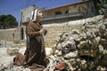 Praying statue in front of mary