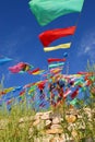 Praying stone and prayer flags on steppe