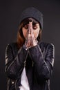 Praying, tattoo or woman in studio for fashion in leather jacket on black background for edgy style. Forgive, hope or Royalty Free Stock Photo