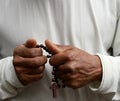 man praying to God with hands held together with people sock image stock photo