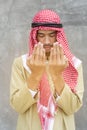 Praying to god with handsome arab man