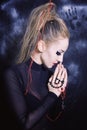 Praying woman with make-up in Gothic style