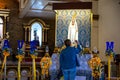 Praying woman in May in front of Madonna Statue in Cathedral Our Lady of the Immaculate Conception, Batan Islands, Philippines