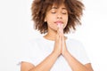 Praying young afro american girl. African woman in summer shirt on white background. Copy space. Mock up. Make a wish. Royalty Free Stock Photo