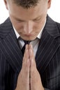Praying young businessman