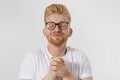 Praying young man isolated on white background. Copy space. Make a wish and fortune concept. Redheaded guy with red beard Royalty Free Stock Photo