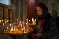 Praying young woman with candle Royalty Free Stock Photo