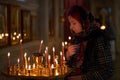 Praying young woman with candle Royalty Free Stock Photo