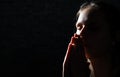 Praying young Woman portrait on dark