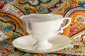 Prcelain cup with saucer in multi colours Royalty Free Stock Photo