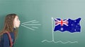 Pre-adolescent girl blowing on Australia flag