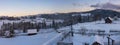 Pre-dawn alpine small quiet village and winter snowy mountains around panorama view Royalty Free Stock Photo