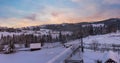 Pre-dawn alpine small quiet village and winter snowy mountains around panorama view Royalty Free Stock Photo