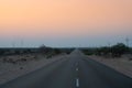 Pre dawn light in desert sky with empty road, passing through the desert. Wind mills in the horizon, Thar desert, Rajasthan, India