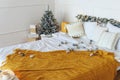 Pre-holiday Christmas bustle. Christmas decorations scattered on the bed decorated with a garland. In the far corner