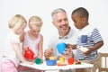 Pre School Children Enjoying Tea Party With Teacher Royalty Free Stock Photo