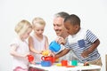 Pre School Children Enjoying Tea Party With Teacher Royalty Free Stock Photo