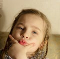 Pre-school girl sitting at the table, pouting Royalty Free Stock Photo