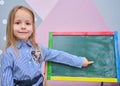 pre school happy little girl standing by blackboard kindergarten children