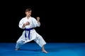 Pre-teen boy doing karate on a black background Royalty Free Stock Photo