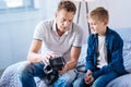 Pre-teen boy and his father discussing new VR headset