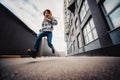 Pre-teen boy on a street in a big city next to a high-rise building alone. Royalty Free Stock Photo