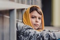 Pre-teen boy on a street in a big city next to a high-rise building alone. Royalty Free Stock Photo