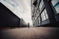 Pre-teen boy on a street in a big city next to a high-rise building alone. Royalty Free Stock Photo