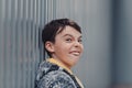 Pre-teen boy on a street in a big city next to a high-rise building alone. Royalty Free Stock Photo