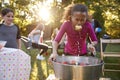 Pre-teen girl, apple in mouth, apple bobbing at garden party Royalty Free Stock Photo