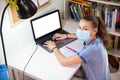 Pre-teen Caucasian girl doing school exercises online using webcasting, distance education during covid-19 pandemic Royalty Free Stock Photo