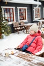 Pre-teen girl in outdoor cafe on winter Royalty Free Stock Photo