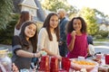 Pre-teen girls smiling to camera at a block party, close up