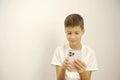 A Pre-teen sit on the couch using smartphone and look sad and boring Royalty Free Stock Photo