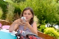 Pre teenager girl texting on mobile phone Royalty Free Stock Photo