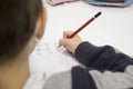 Pre-writter child boy doing calligraphy exercises with booklets Royalty Free Stock Photo