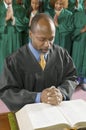 Preacher by altar in church Bowing Head in Prayer