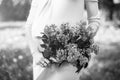 Preagnant woman in the park with purple flowers Royalty Free Stock Photo