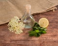 Preaparation for home made Elderberry syrup. Home made with sugar, and lemons. On the wooden background.