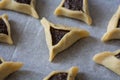 Prebaked `Haman pockets`, also known as Hamantashen, an Ashkenazi Jewish triangular filled-pocket cookies, usually associated with Royalty Free Stock Photo