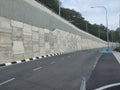 Precast concrete retaining wall panels are installed in layers as a retaining wall. Royalty Free Stock Photo