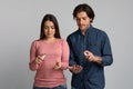 Precautions During Coronavirus Outbreak. Young couple applying disinfectant spray on hands