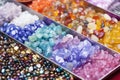 precious gemstones and colored beads waiting to be assembled into earrings