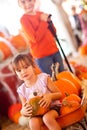 Precious Girl Riding Wagon with Her Pumpkin and Sister Royalty Free Stock Photo