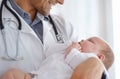 Precious little life. a handsome male doctor holding a baby. Royalty Free Stock Photo